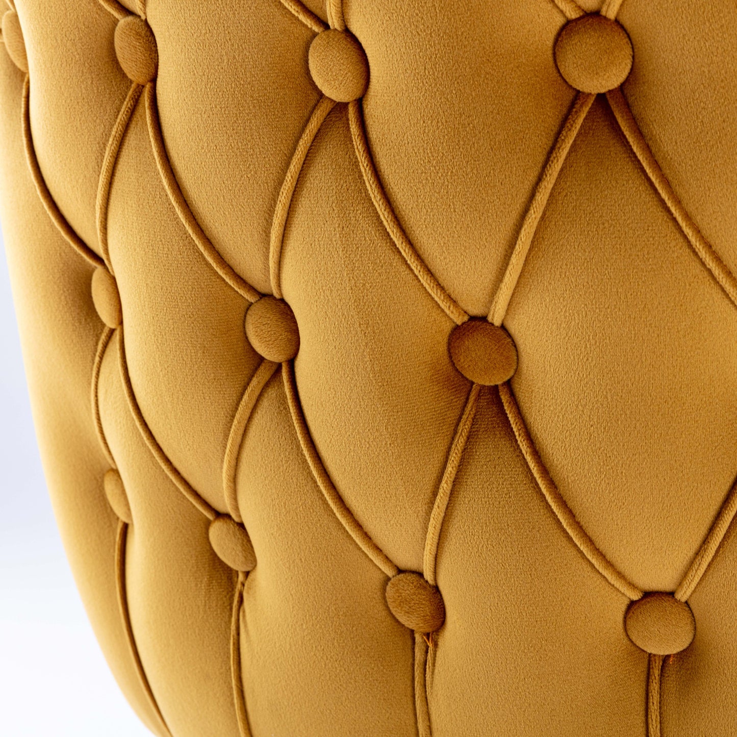 Closeup of mustard velvet tufted sofa fabric