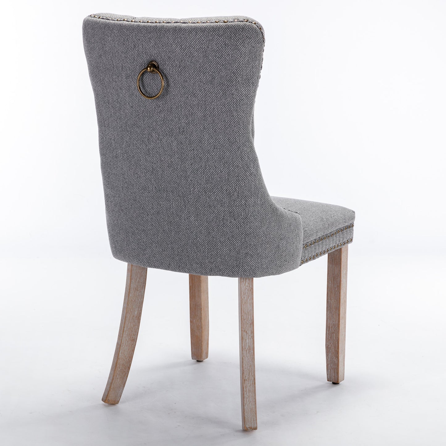 Grey fabric dining chair with antique brass ring pull and nailhead trim