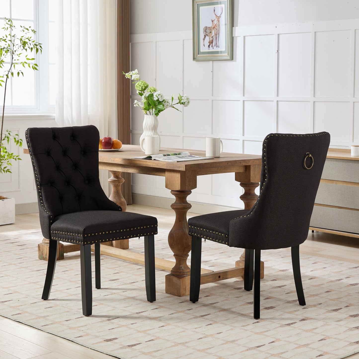 Tufted black upholstered dining chair with antique brass nailhead trim