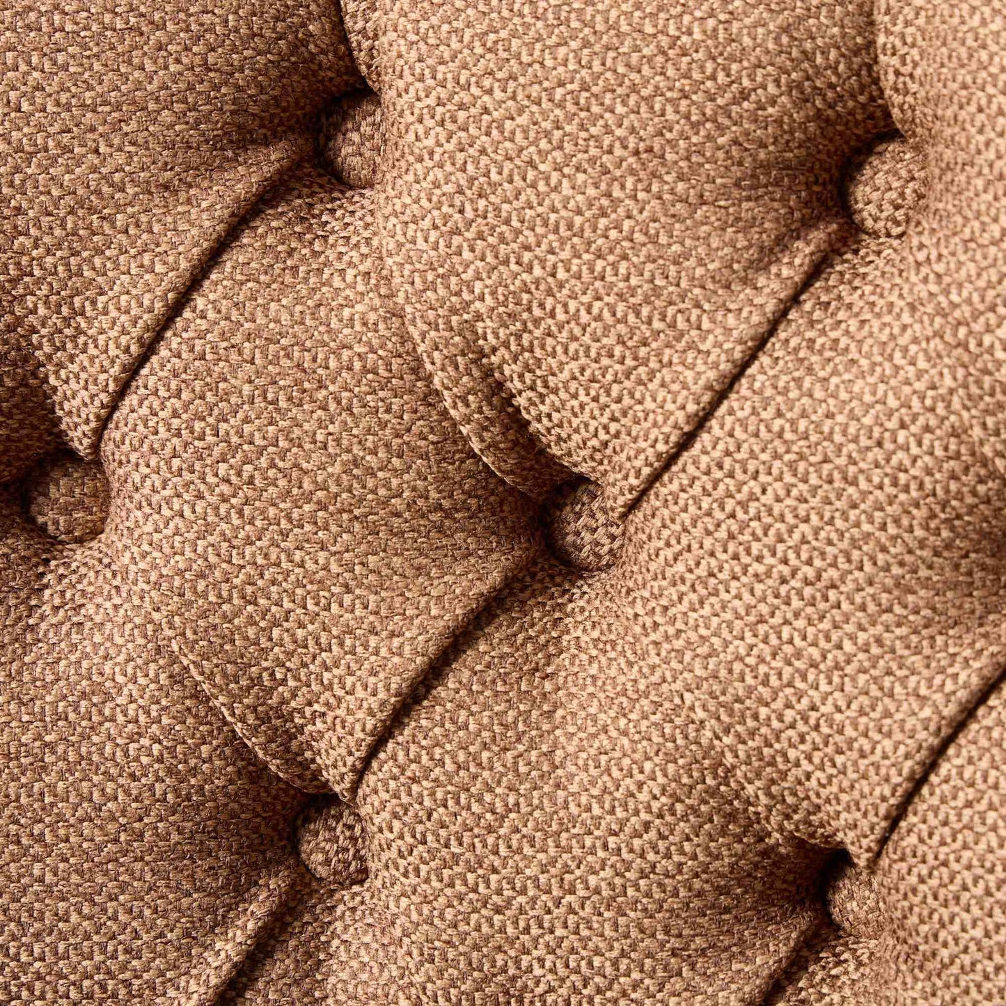 Closeup of tufted brown textured fabric upholstery