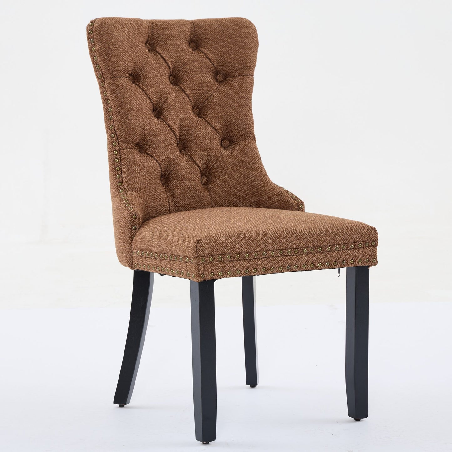Brown tufted dining chair with brass nailhead trim and dark wooden legs