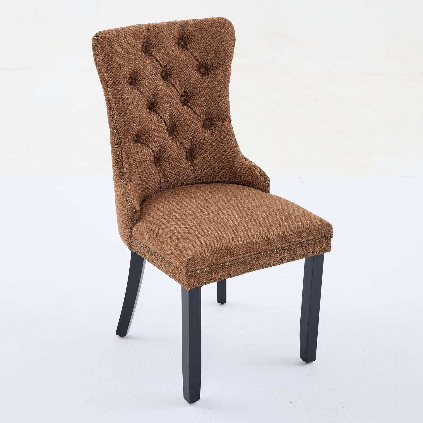 Brown upholstered dining chair with tufted back and bronze nailhead trim