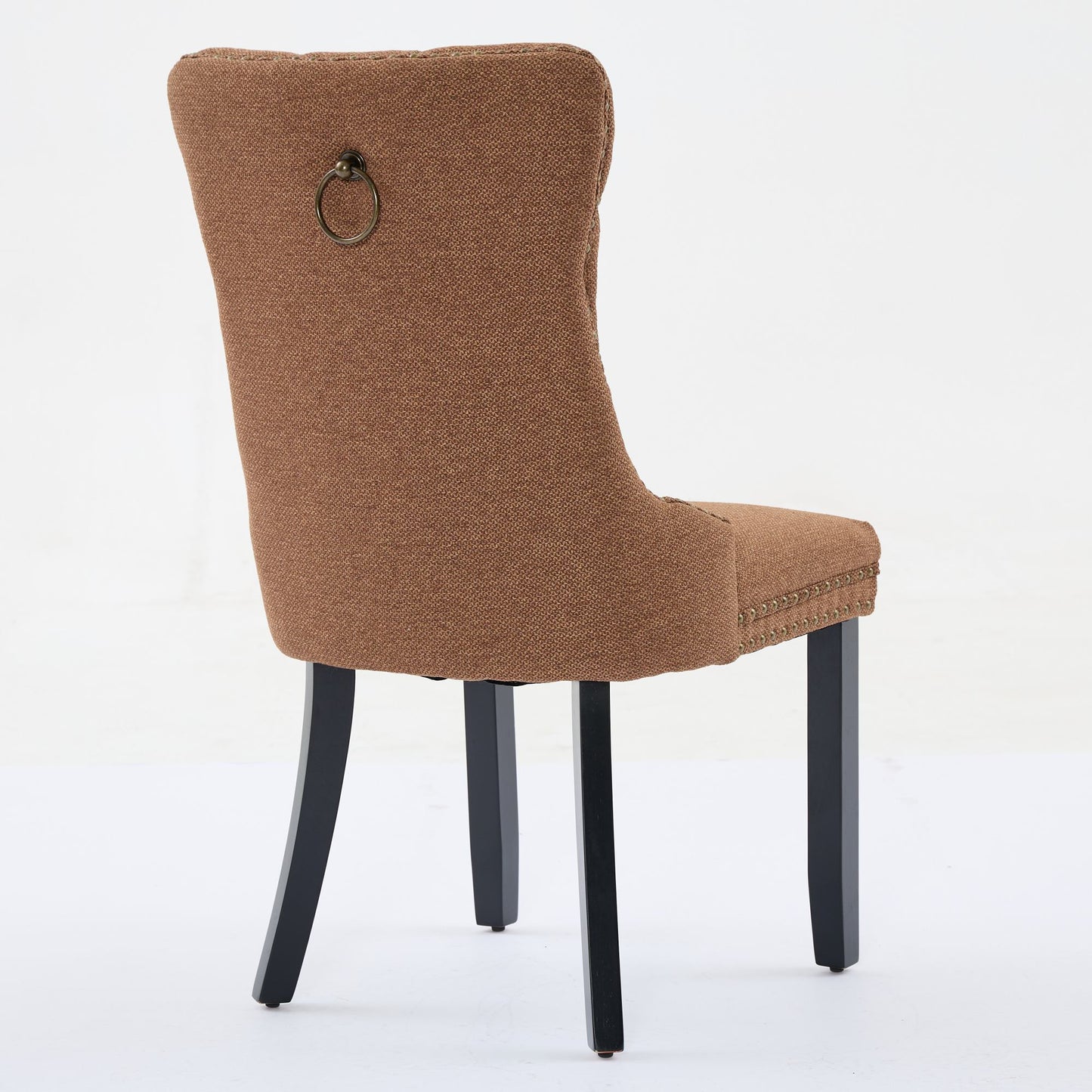 Brown fabric dining chair with brass ring pull and nailhead trim
