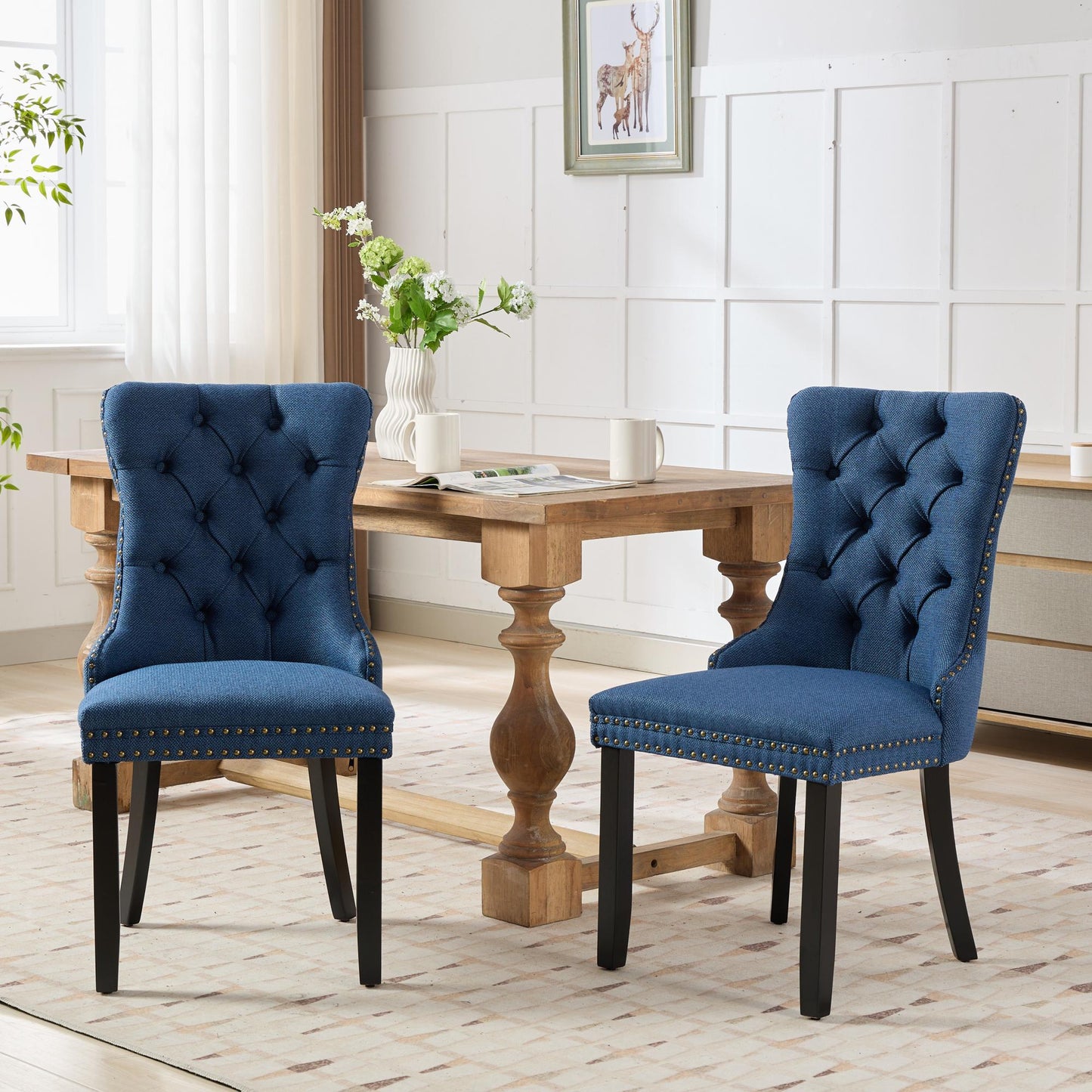 Navy blue tufted dining chairs with brass nailhead trim