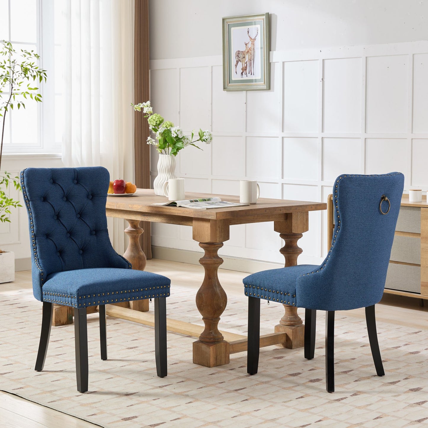 Tufted blue dining chair with gold nailhead trim and ring pull