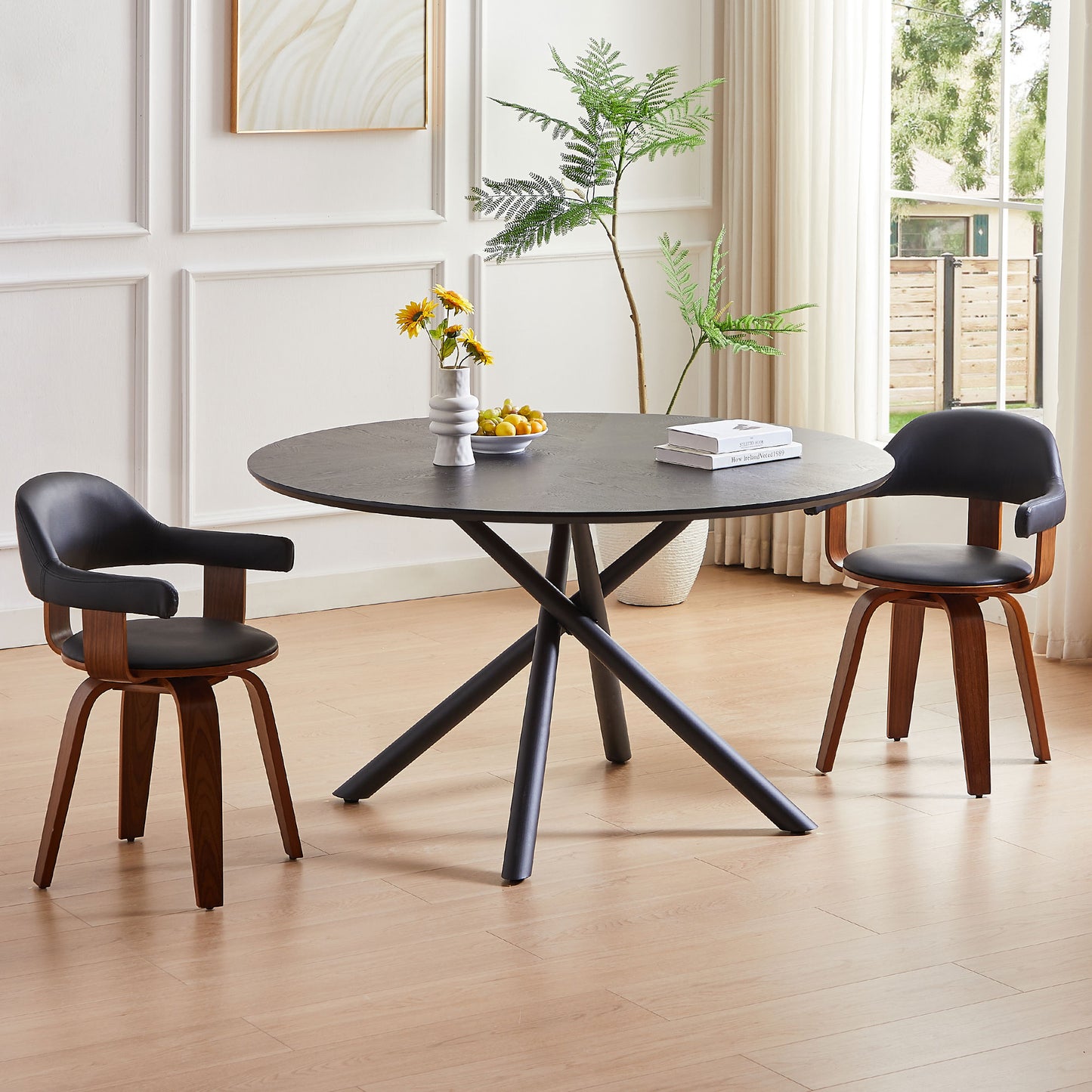 Black round dining table with a modern matte finish and unique crisscross base