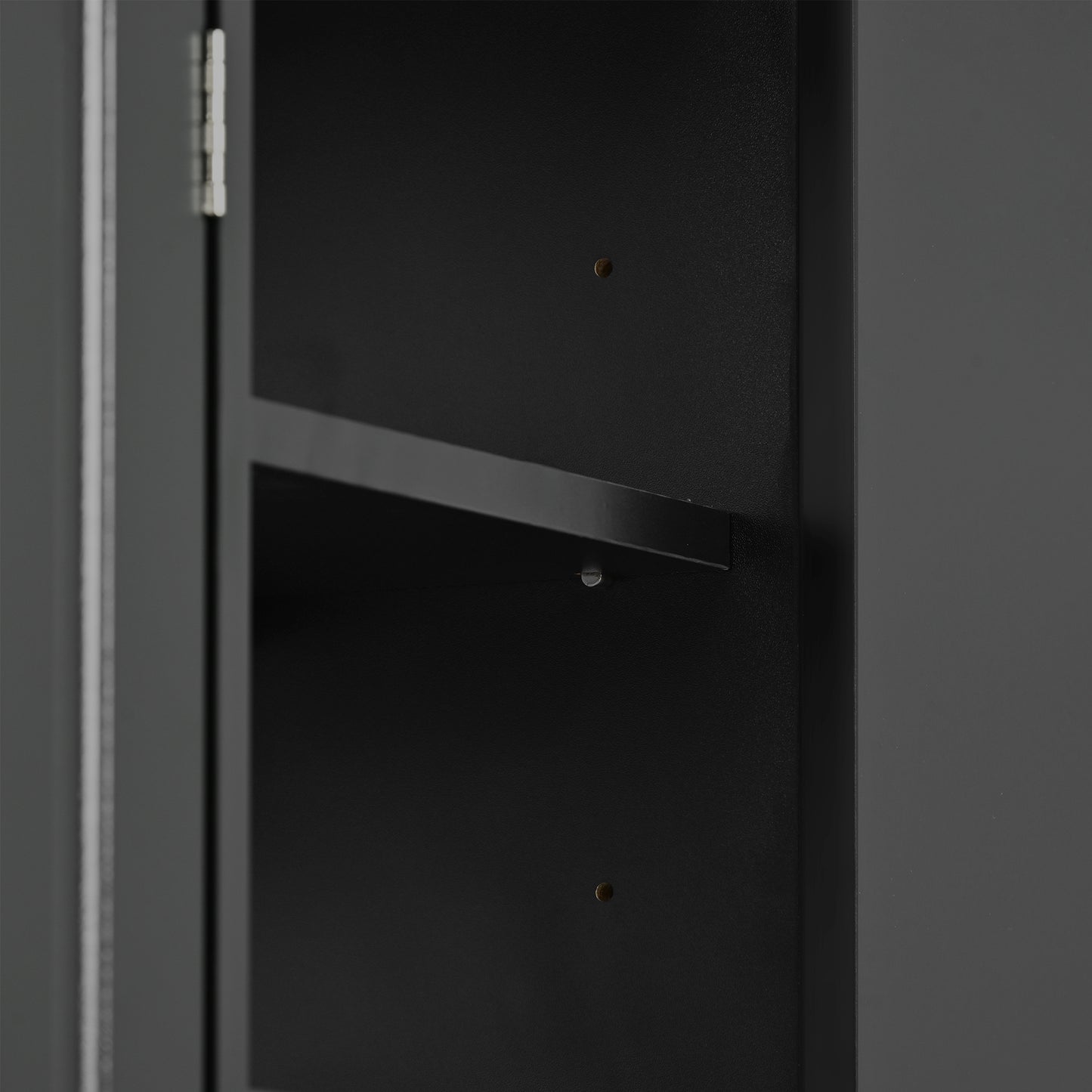 Closeup of a dark gray metal cabinet interior showing a fixed shelf and mounting screws