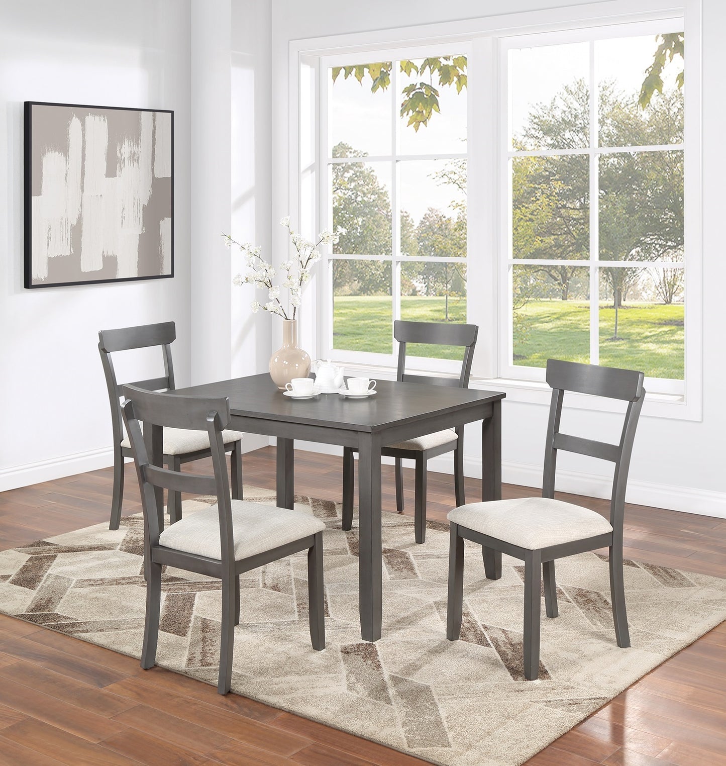 Gray wood dining table set with four upholstered chairs and modern abstract rug