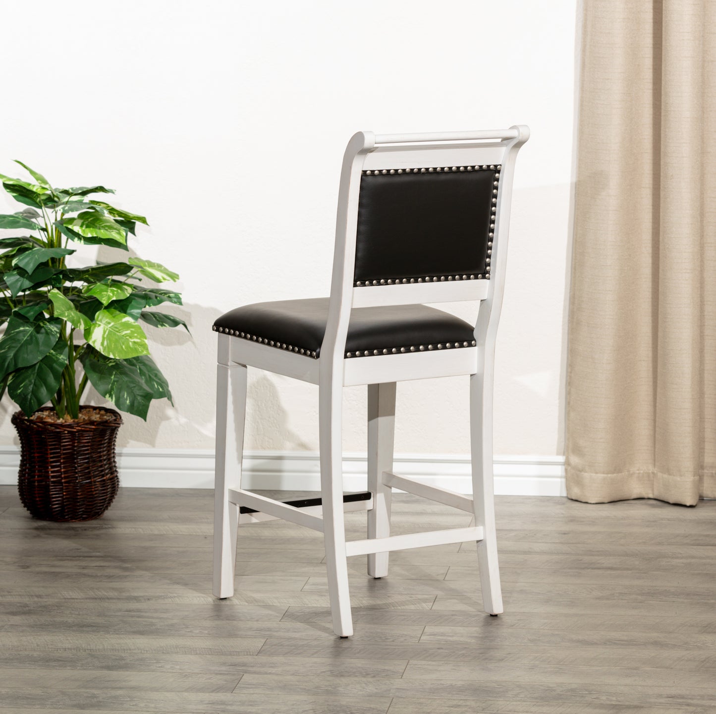 White upholstered bar stool with black faux leather seat and back studded detail