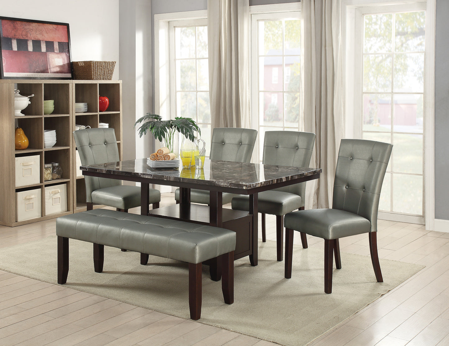 Marble top dining table with four tufted chairs and a bench