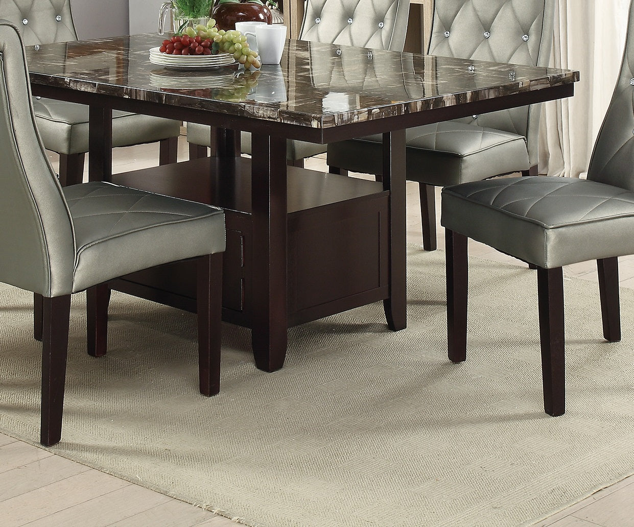 Dark brown wooden dining table with a marbled top and upholstered silver chairs