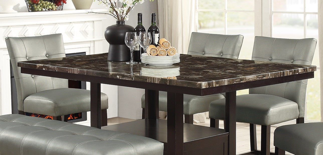Brown marble top dining table with four grey tufted upholstered chairs