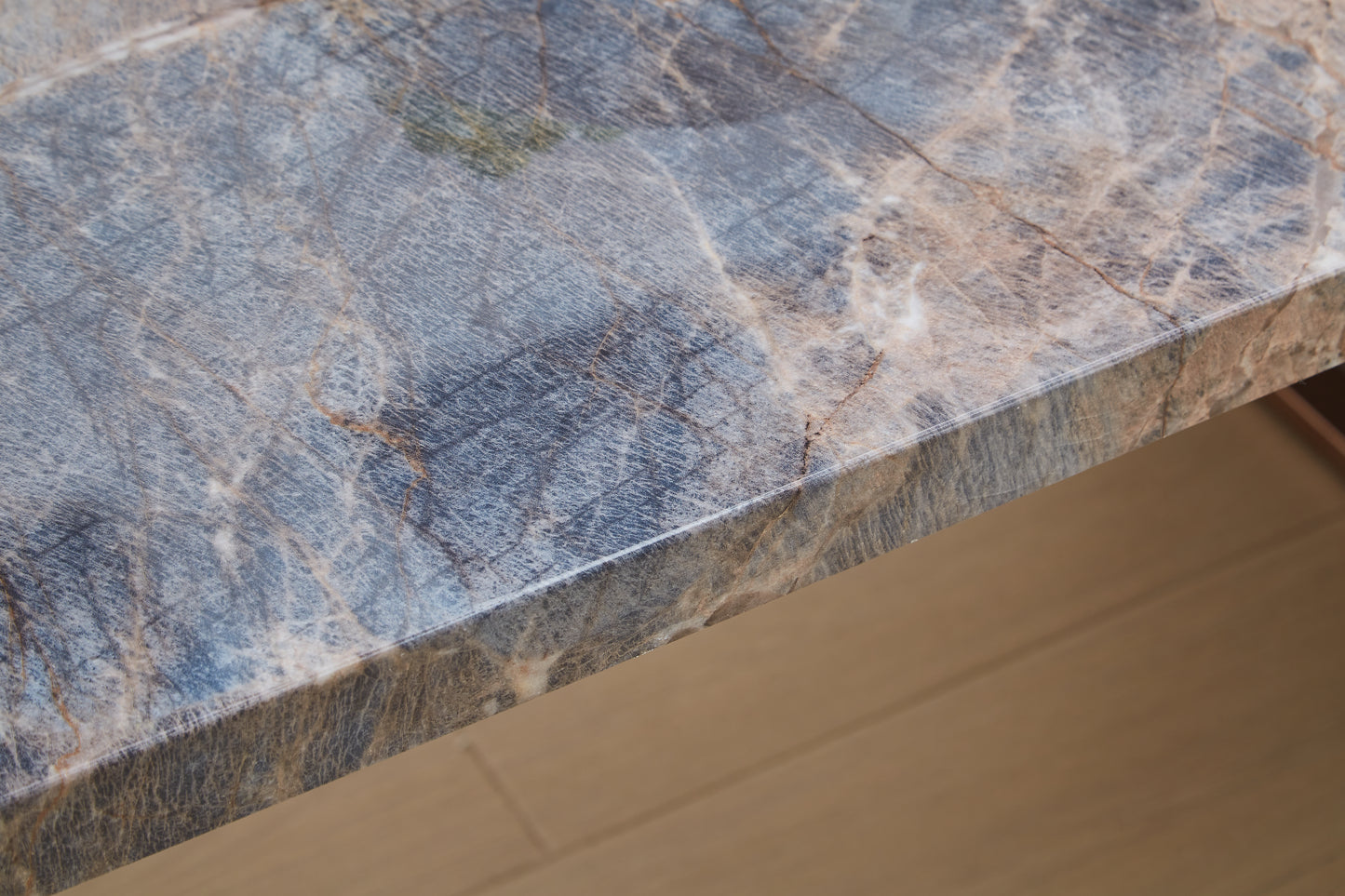 closeup of polished marble slab with blue and beige veins
