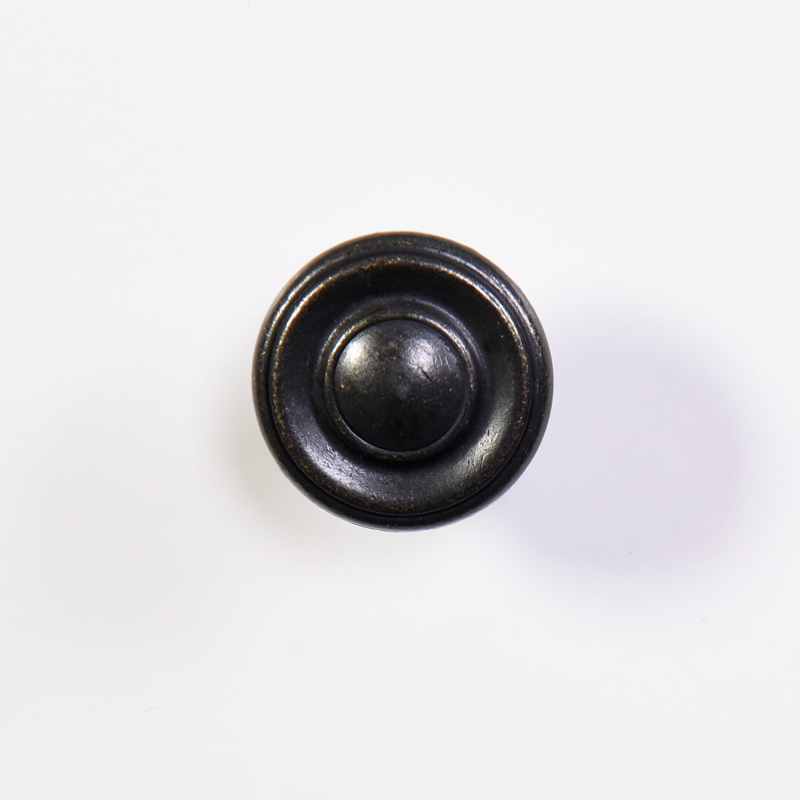 Ornate bronze cabinet knob with tiered concentric circles and a matte finish