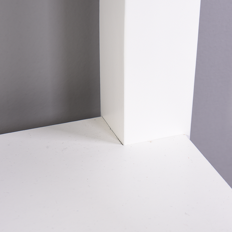 White laminate shelf corner with grey wall