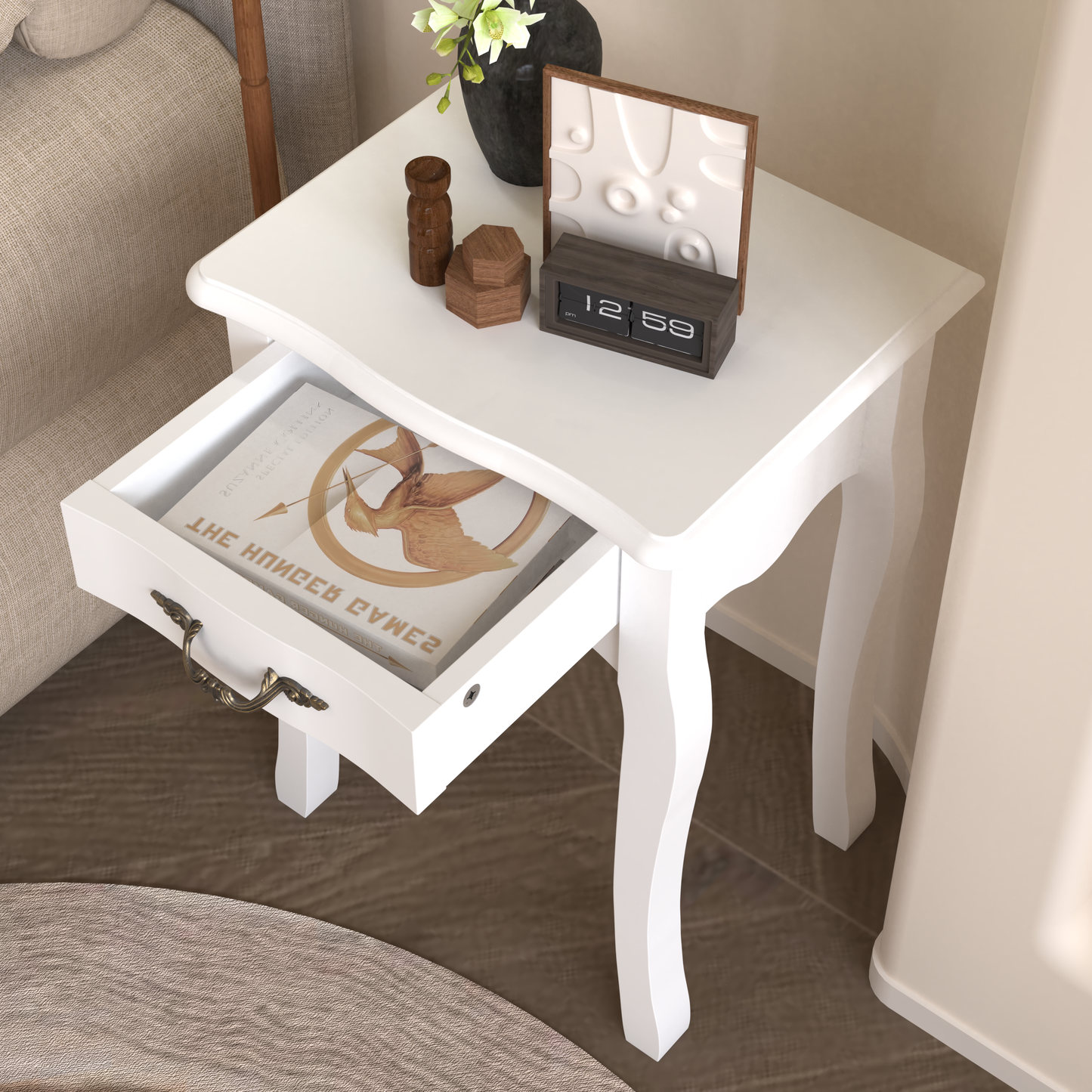 White accent table with ornate brass drawer pull and open drawer revealing a book