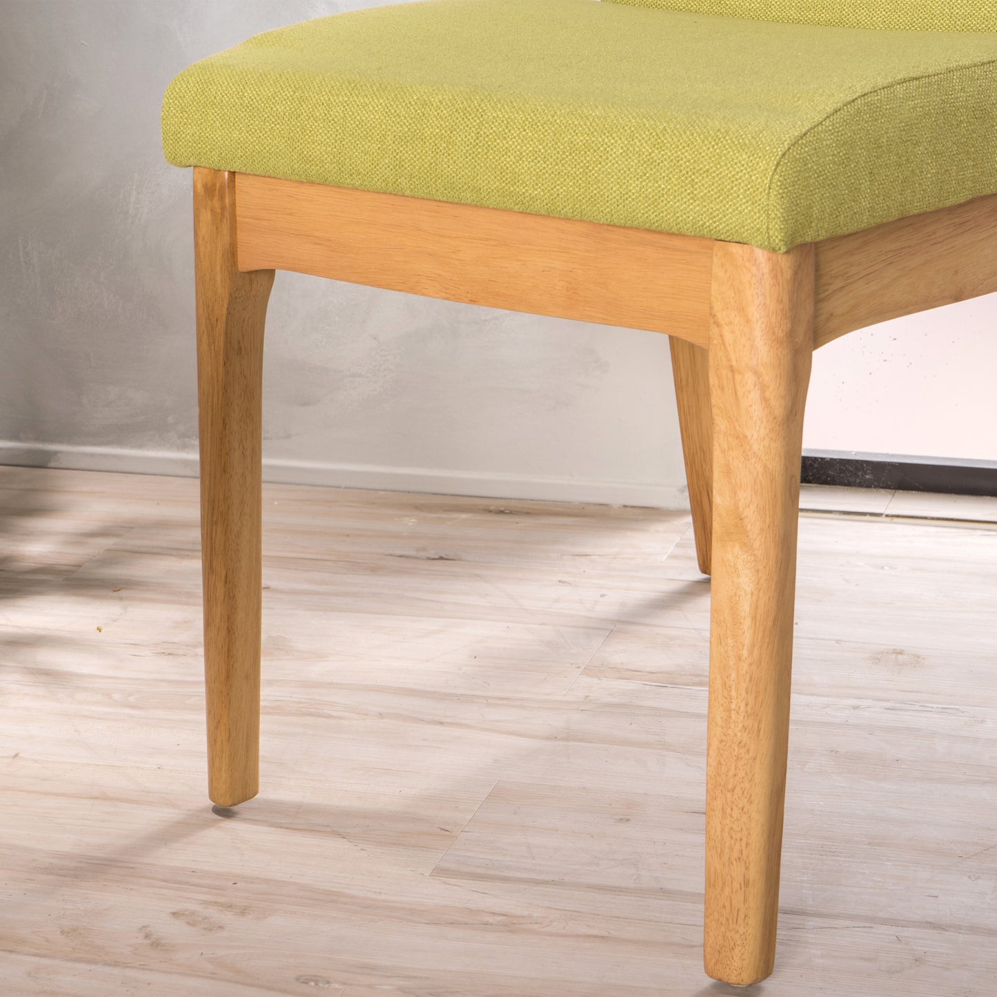 Green upholstered wooden dining chair closeup