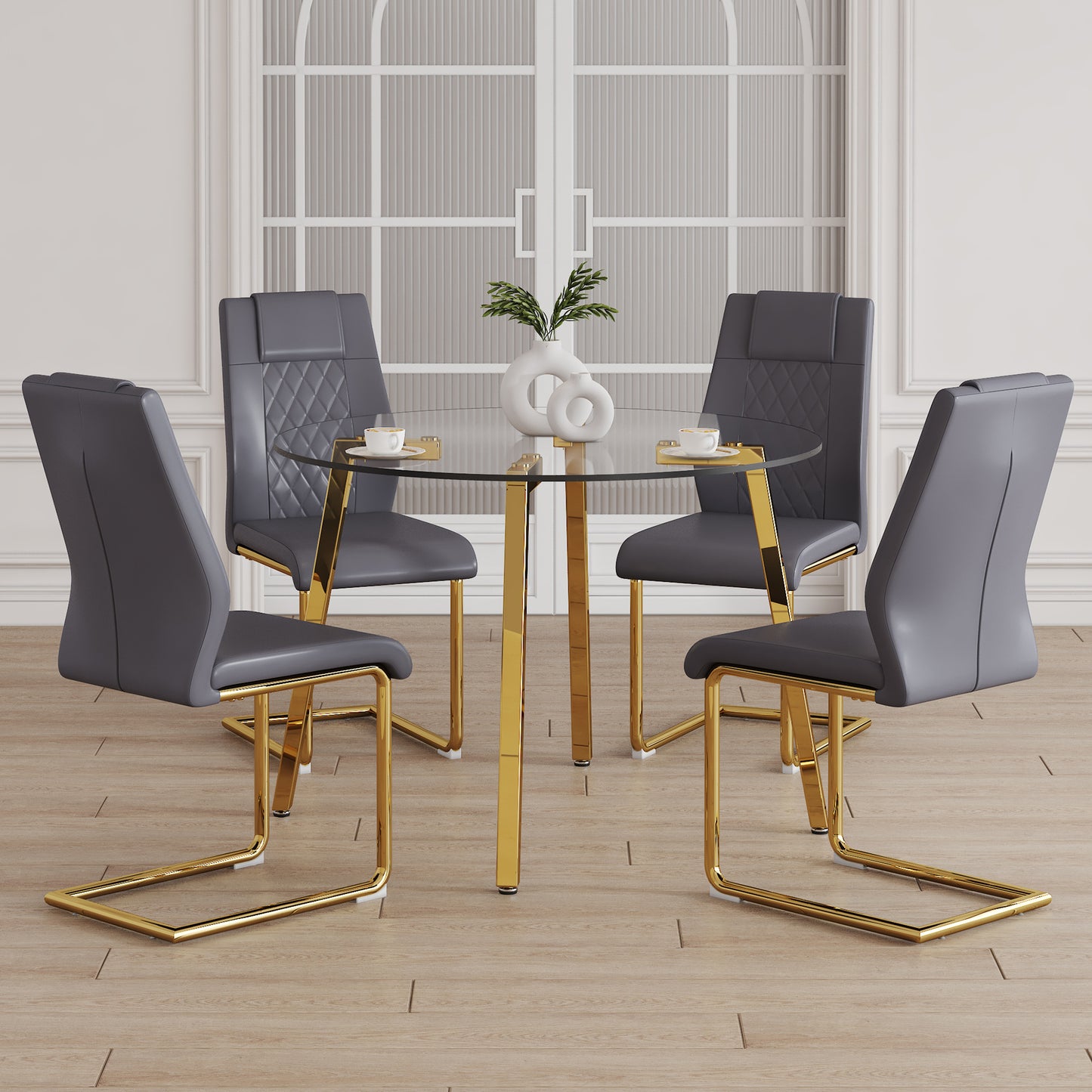 Modern grey faux leather dining chairs with gold sled bases surrounding a glass top table