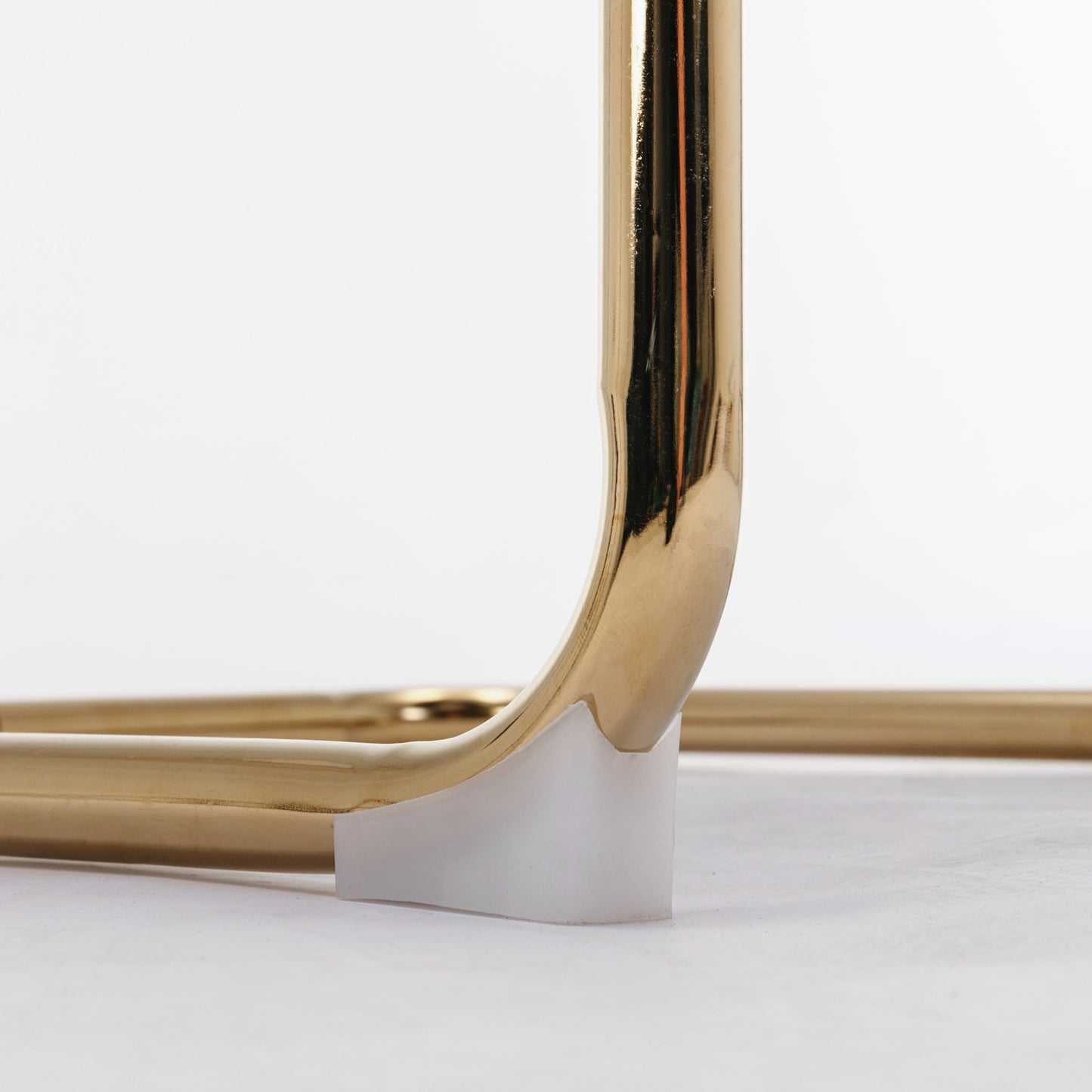 Closeup of polished brass tubing with a white protective cap