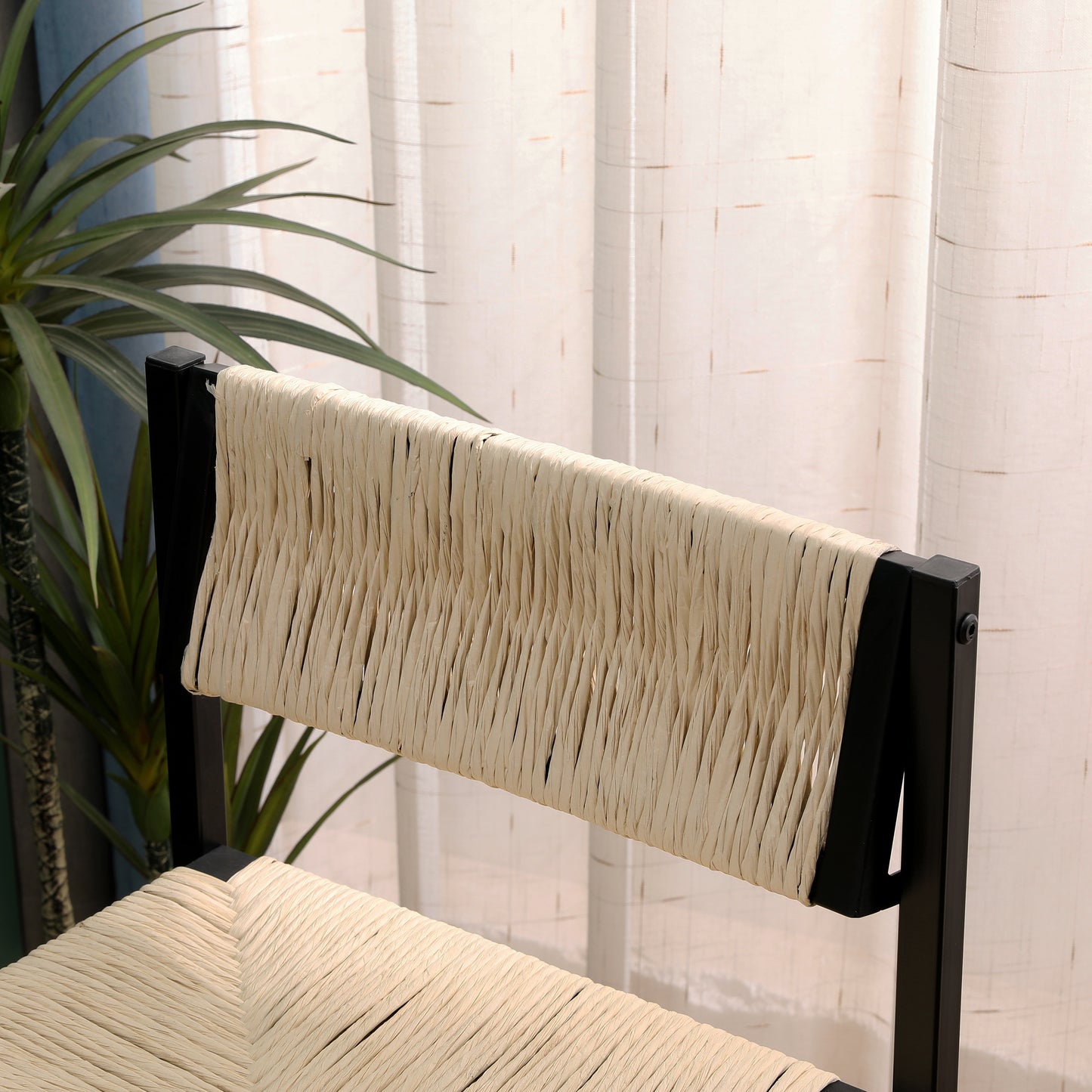 Black metal frame chair with woven raffia seat and back