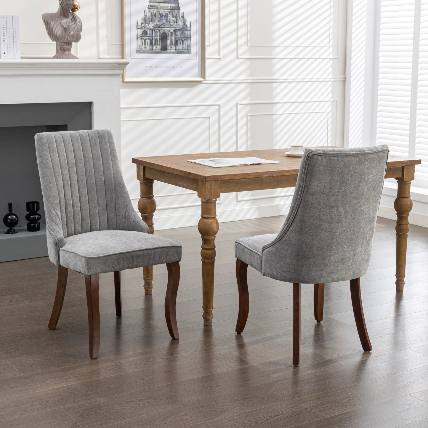 Grey upholstered dining chair with vertical channel tufting and dark wood legs
