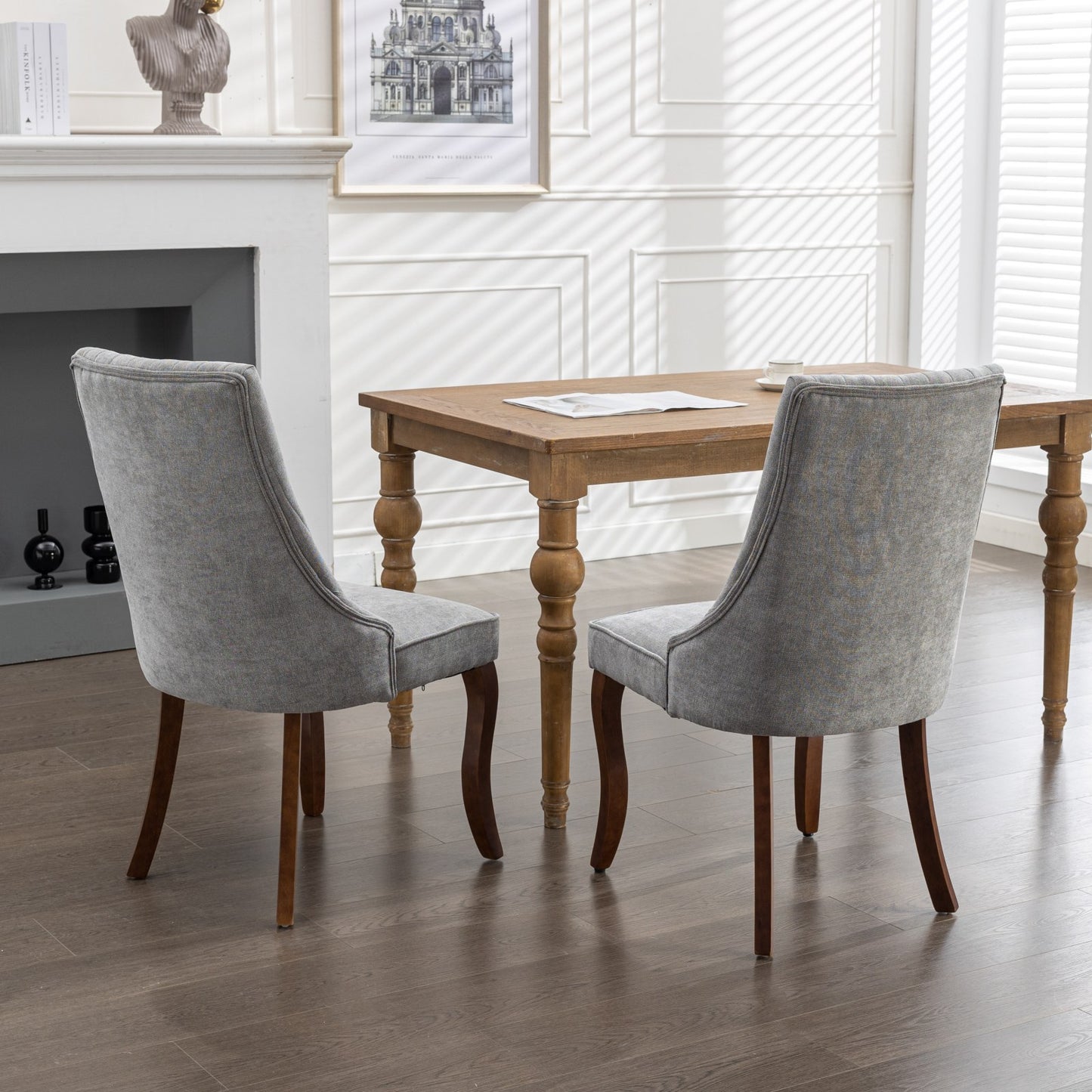 Gray upholstered dining chairs with curved wooden legs