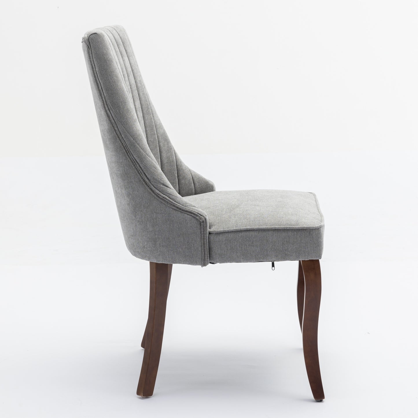 Grey upholstered dining chair with button tufting and wooden legs