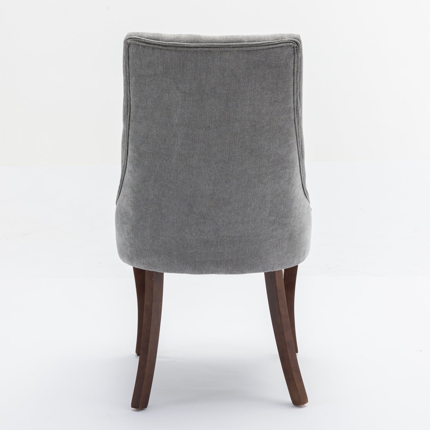 Grey upholstered dining chair with dark wood legs