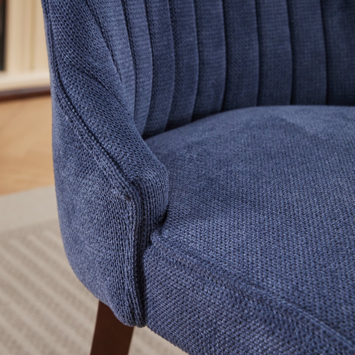 Close up of textured navy blue fabric on a modern accent chair
