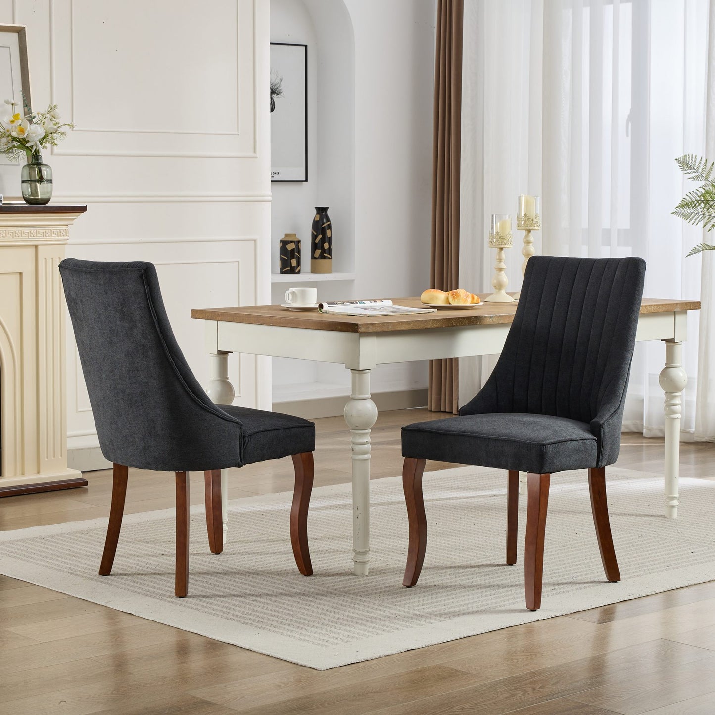 Dark grey upholstered dining chair with vertical channel tufting and dark wood legs
