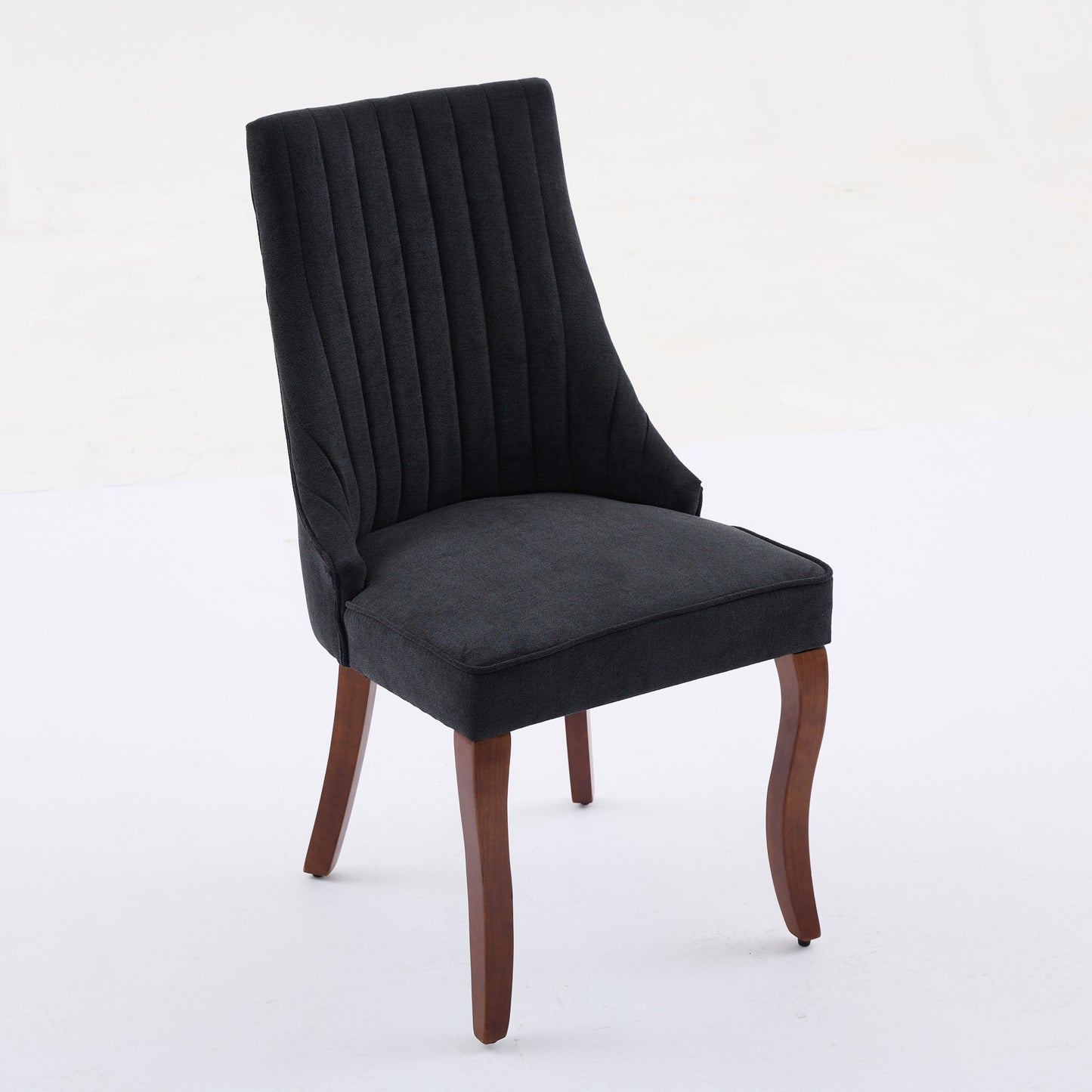 Dark gray upholstered accent chair with vertical channel tufting and curved wooden legs