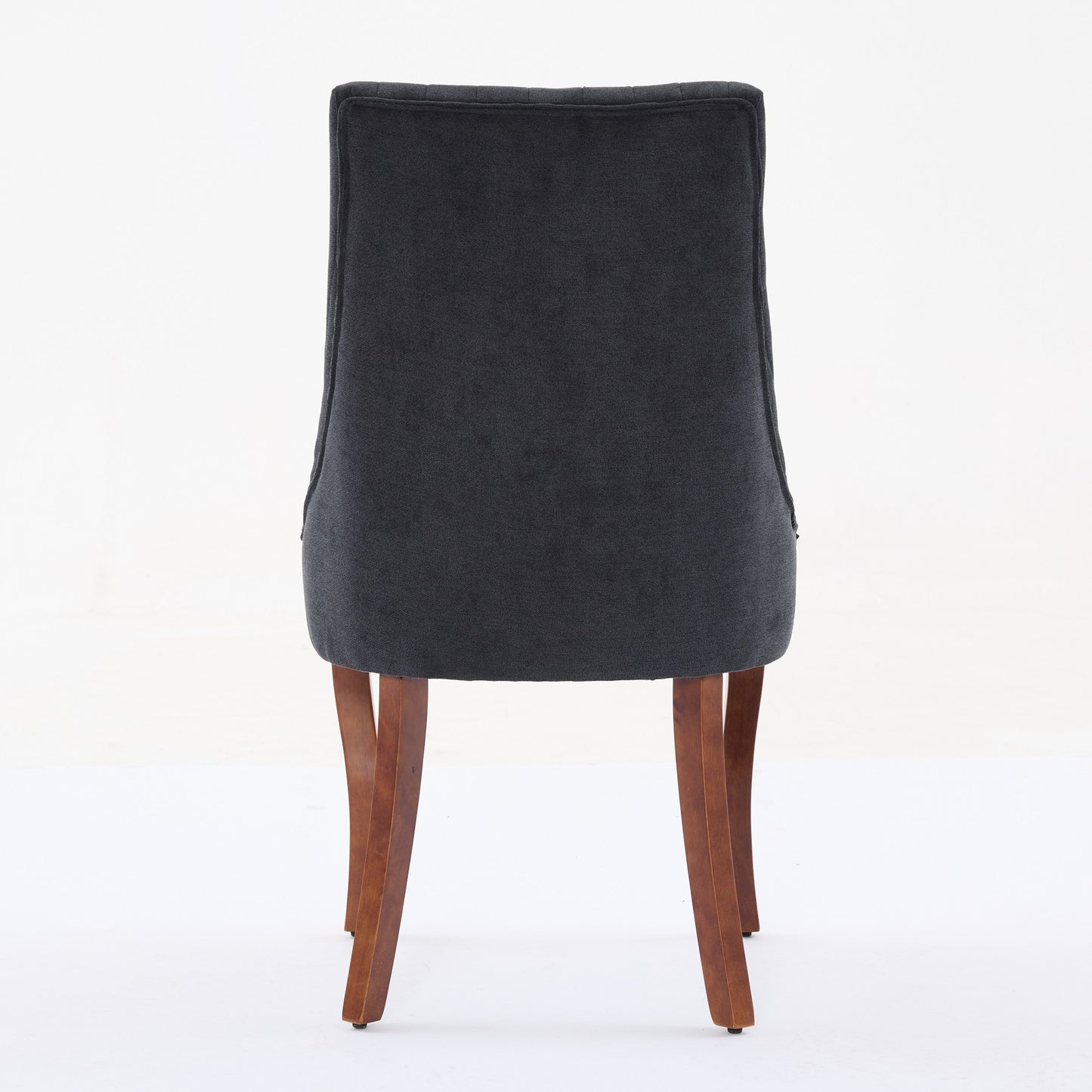 Dark grey fabric dining chair with tufted back and wooden legs