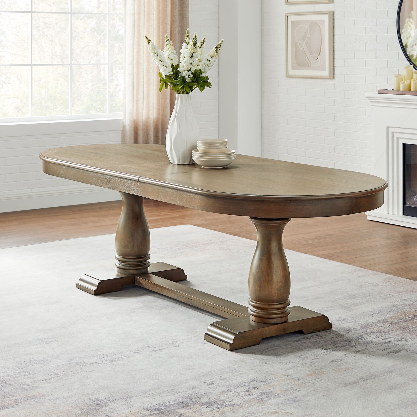 Brown wooden oval dining table with pedestal bases