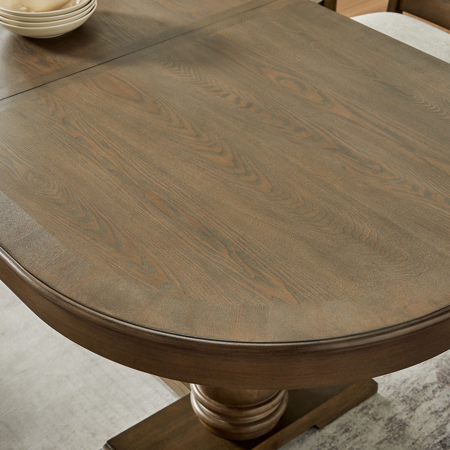 Rustic brown wood oval dining table with pedestal base