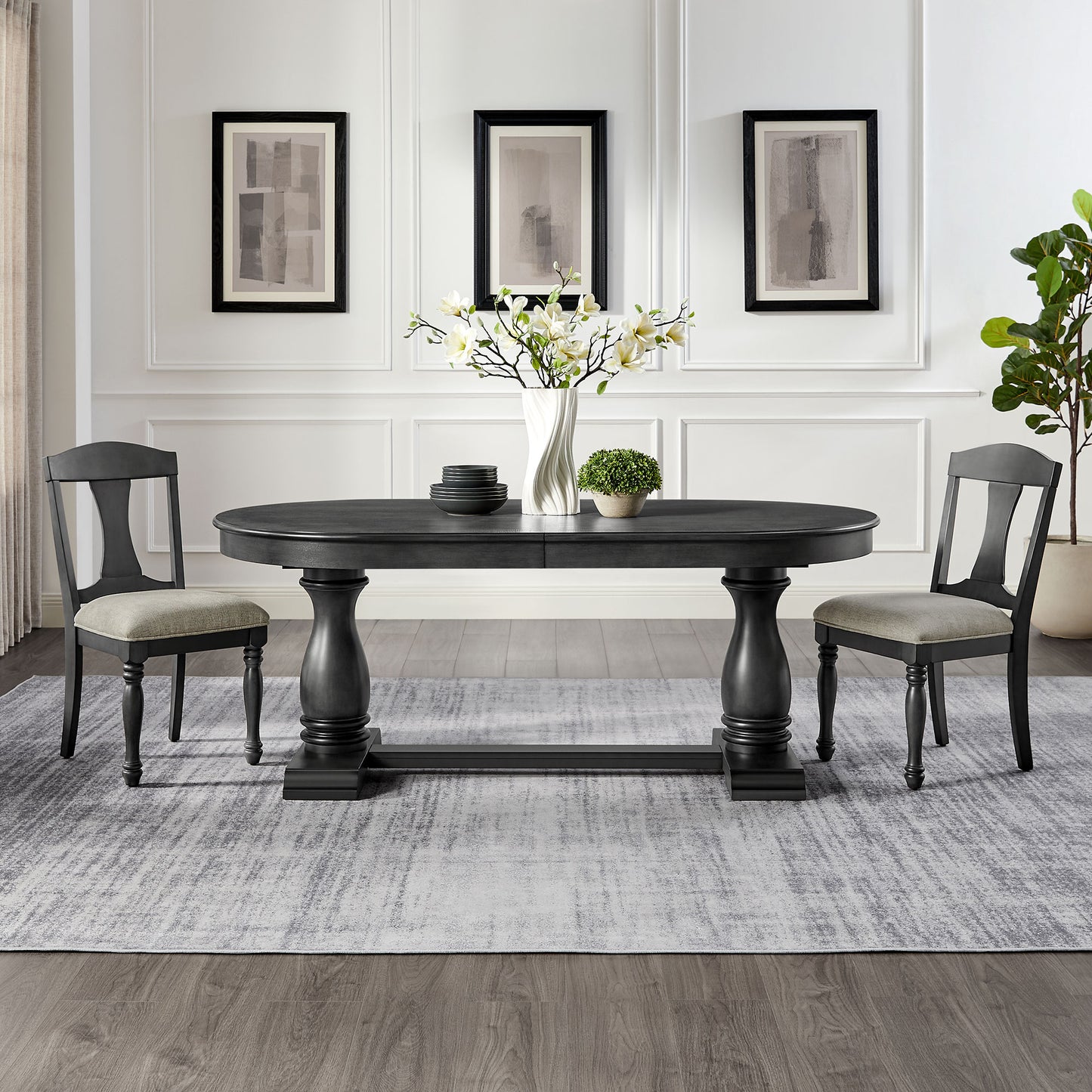 Dark gray pedestal dining table with upholstered chairs