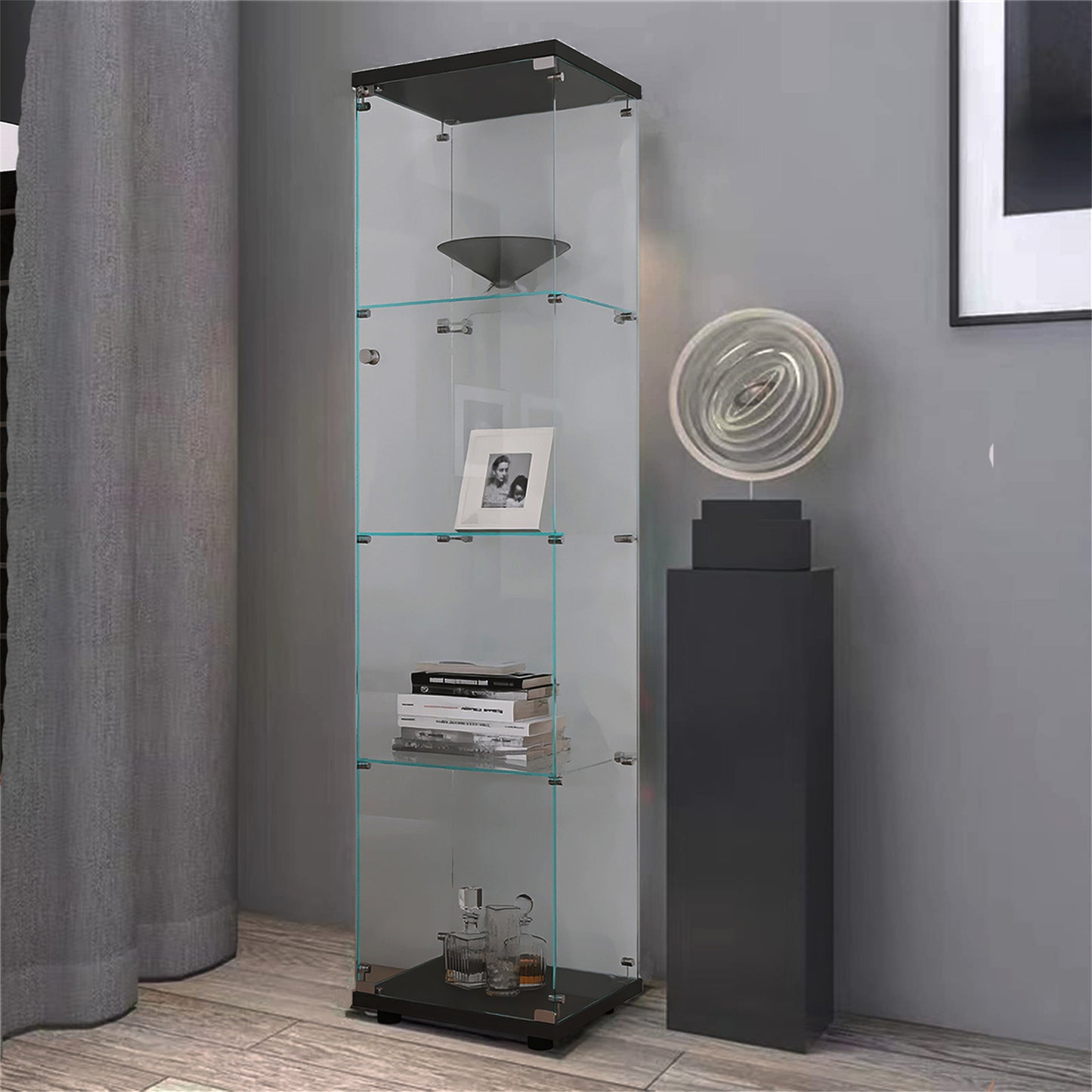 Tall clear glass display cabinet with black base and top holding decorative items
