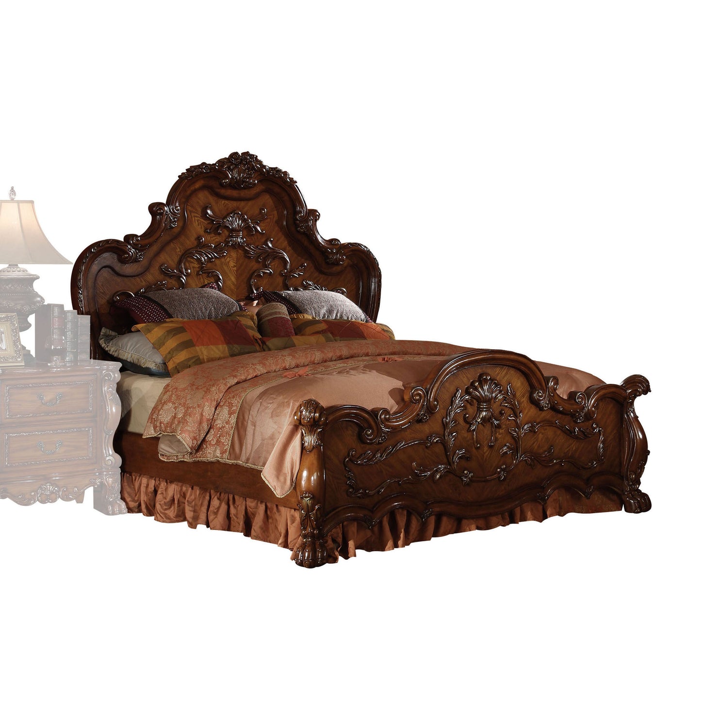 Ornate dark wood king bed frame with carved detailing and plush bedding for a luxurious bedroom