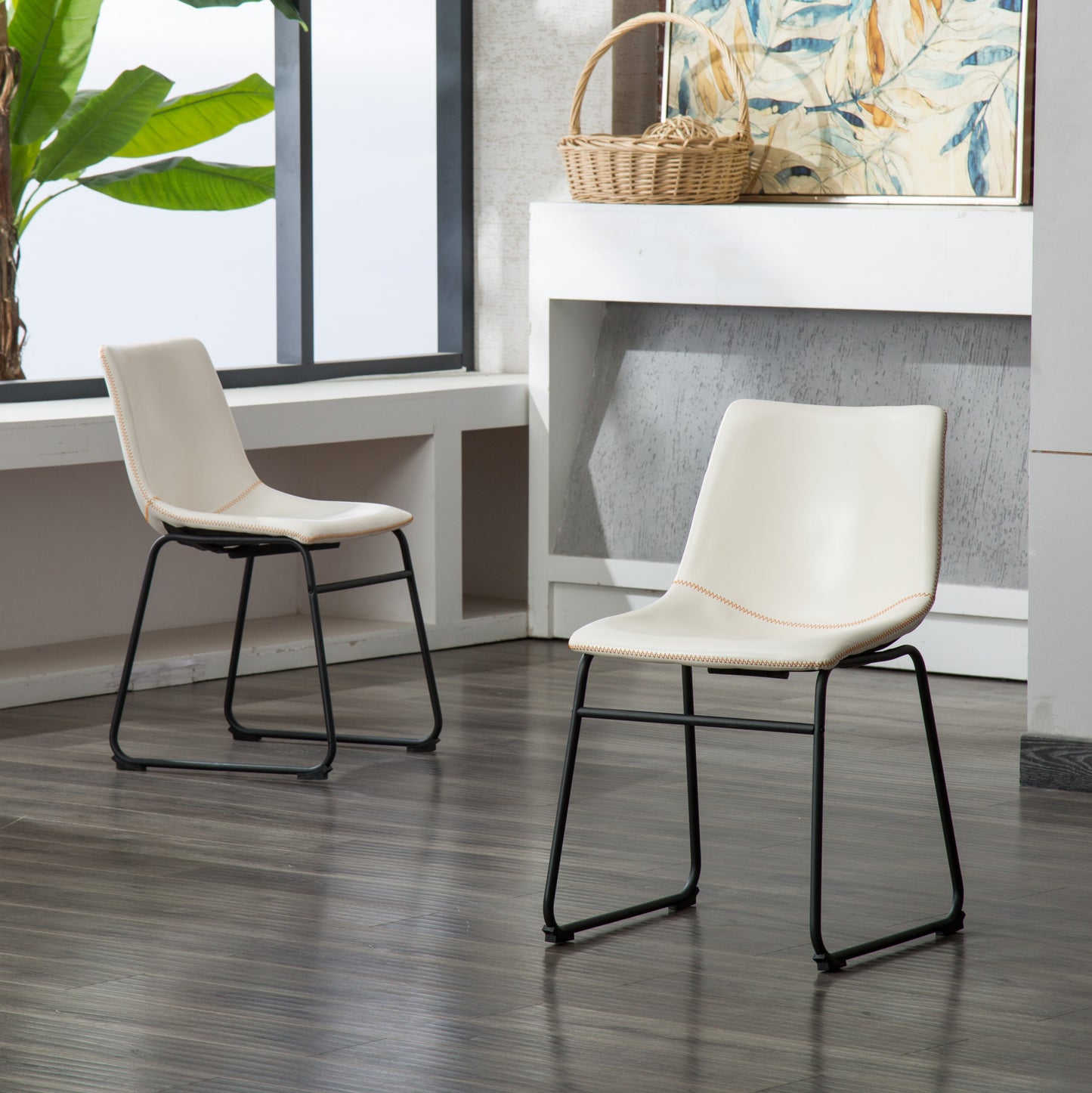 Cream faux leather dining chair with black metal legs and orange stitching