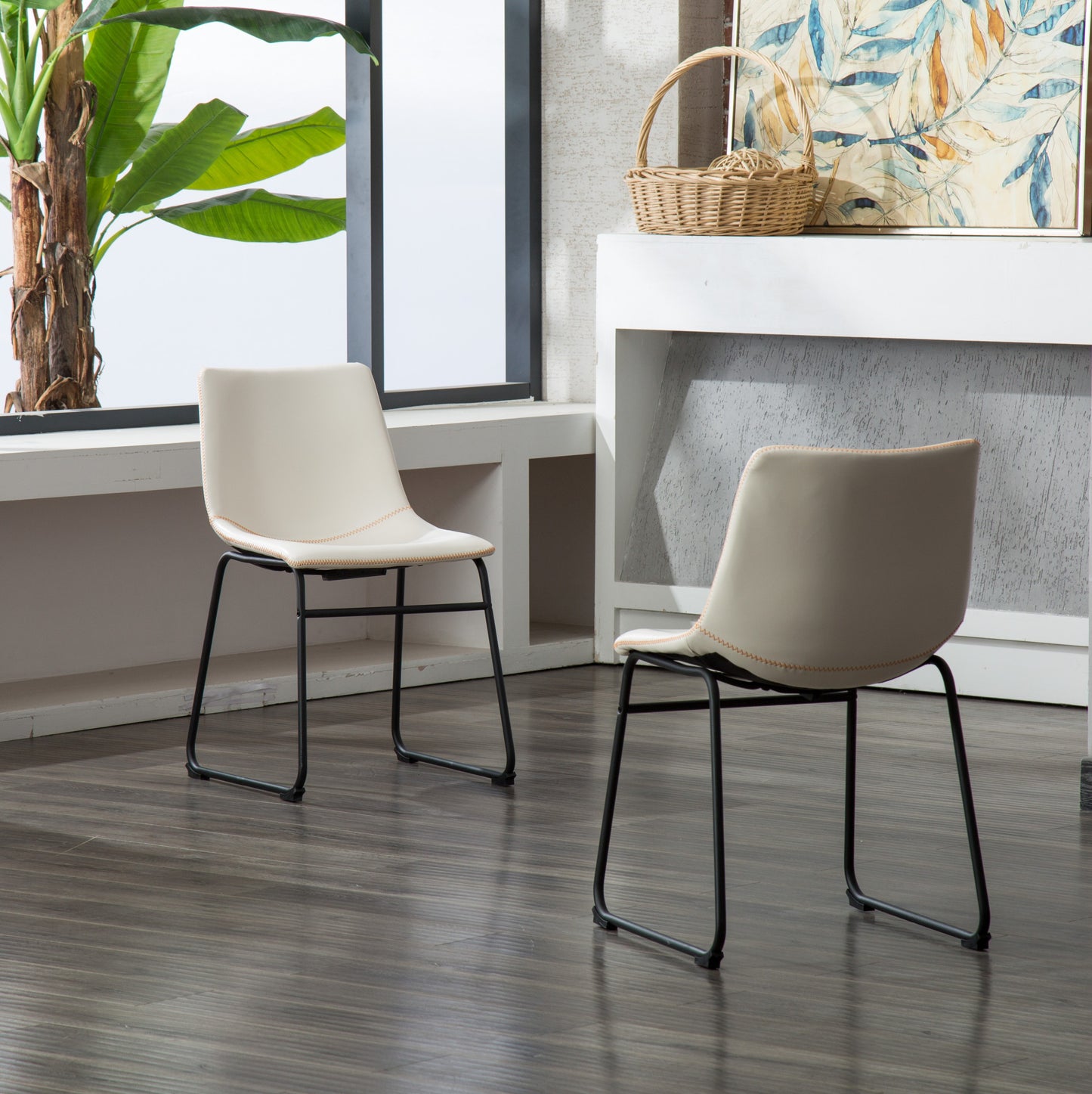 Cream dining chair with black metal legs and orange stitching detail