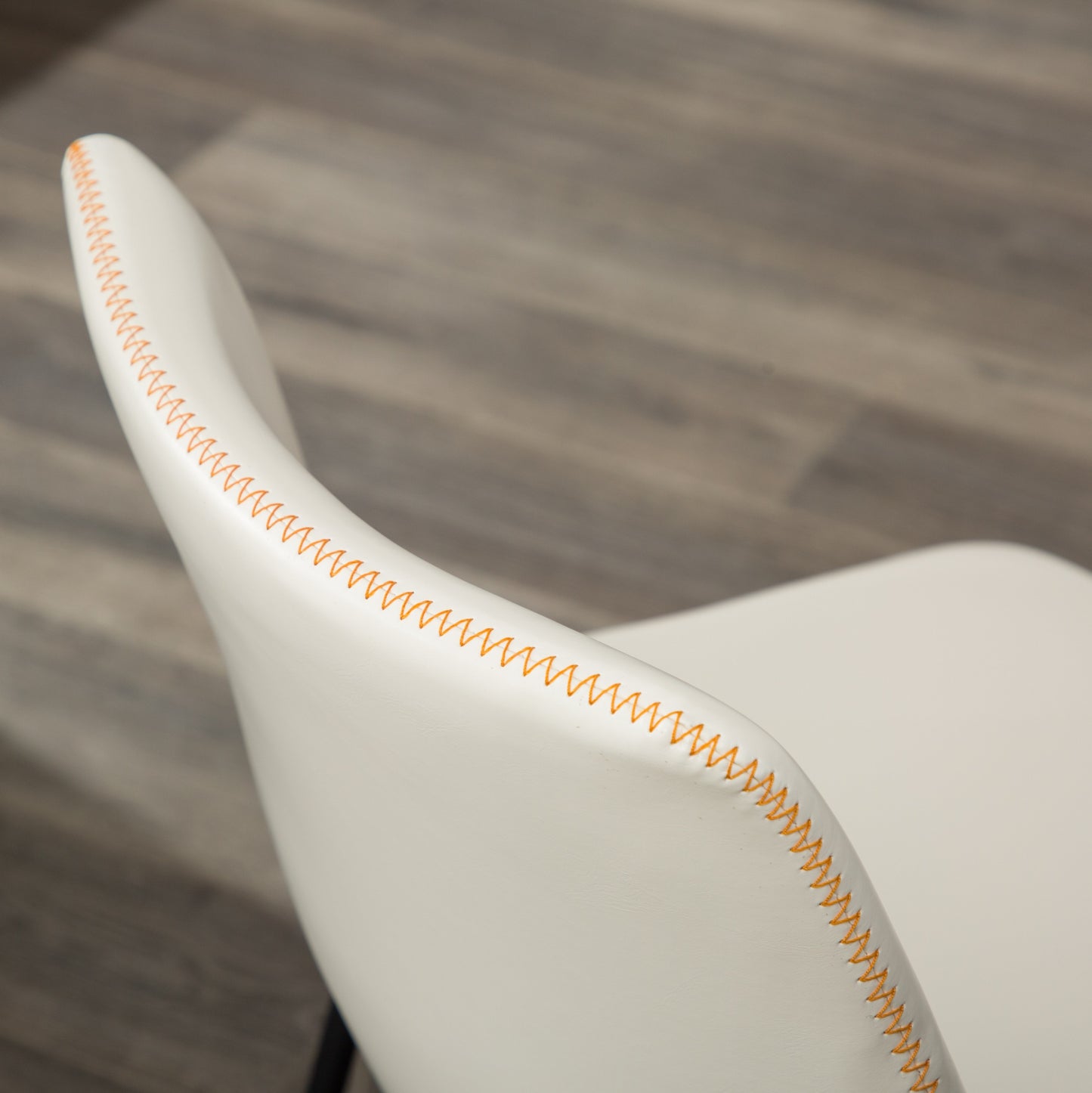 White contemporary chair back with orange stitching detail
