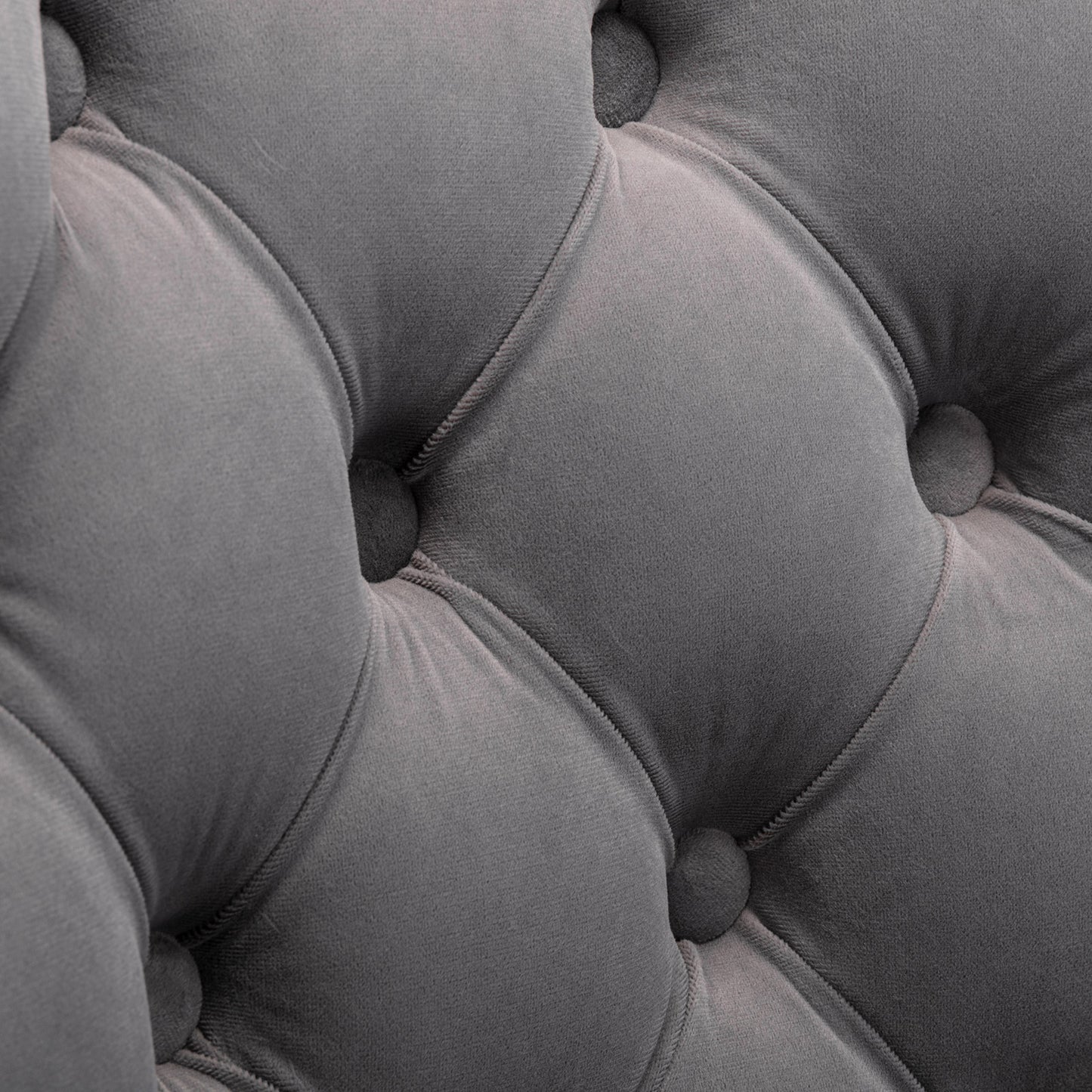 Closeup of tufted grey velvet upholstery