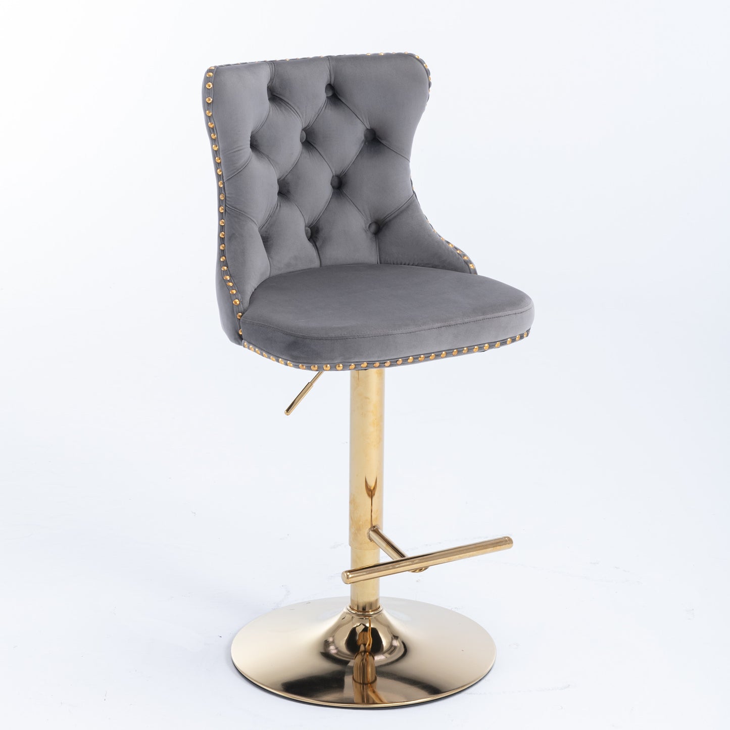 Grey velvet tufted bar stool with gold studded trim and adjustable gold pedestal base