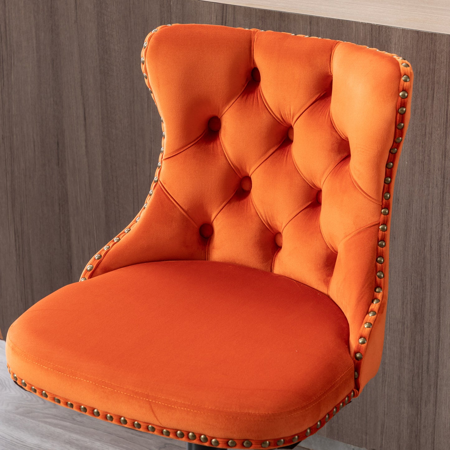 Orange velvet tufted bar stool with antique brass nailhead trim