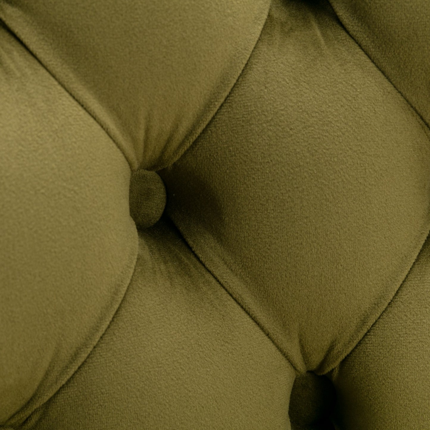 Closeup of tufted olive green velvet fabric texture on a sofa