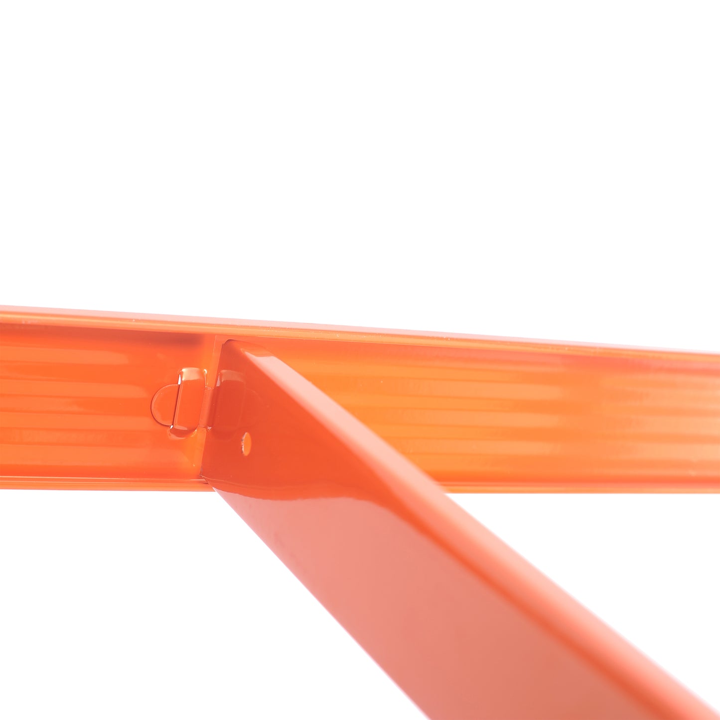 Closeup of bright orange metal bracket with ribbed texture