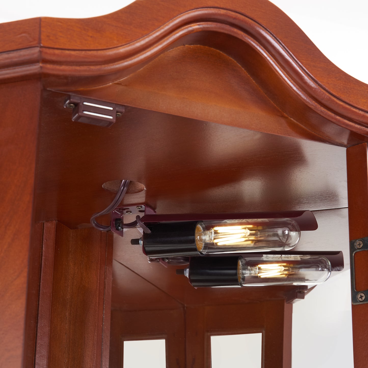 Antique Edison bulb illumination in a cherry wood display cabinet
