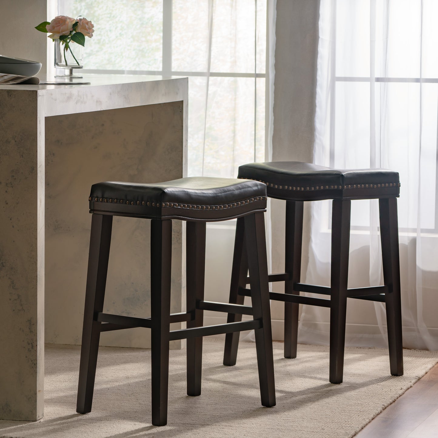 Dark brown faux leather bar stool with nailhead trim and wooden legs