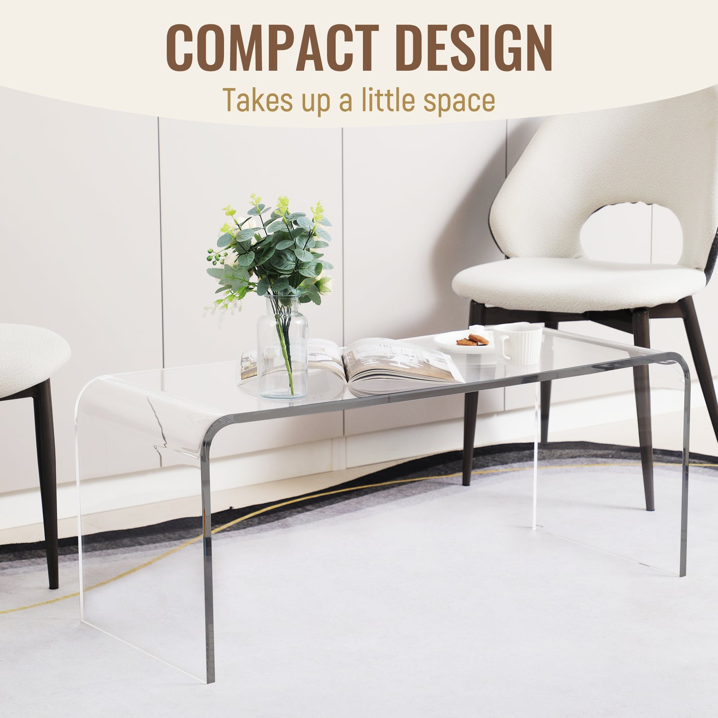 Transparent acrylic coffee table with curved edges featuring a book and flowers