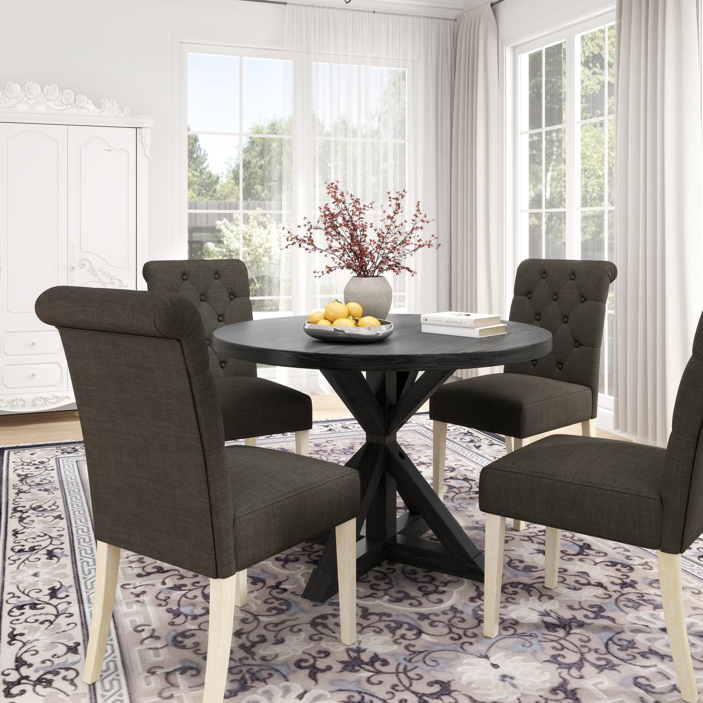 Dark grey tufted dining chairs around a round black dining table