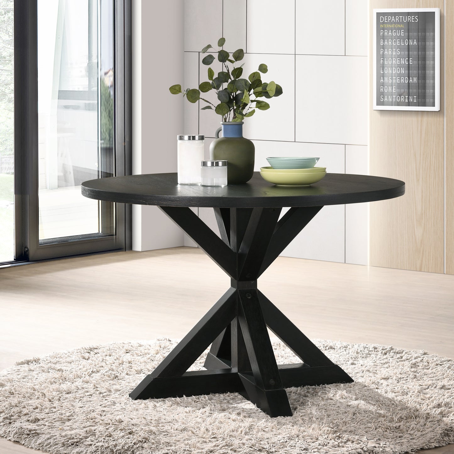Dark wood round dining table with geometric base on shaggy rug